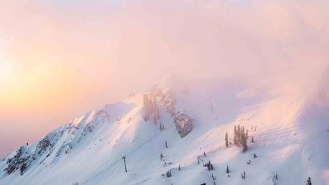 The sun rising over Headwall on a December powder day.