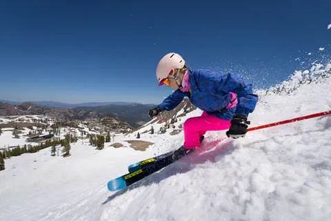Grarbie skiing spring snow in neon pink pants.