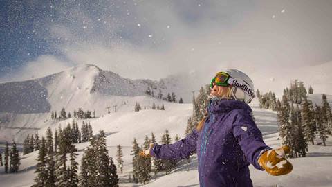 A woman throws snow up in the air at Alpine. 