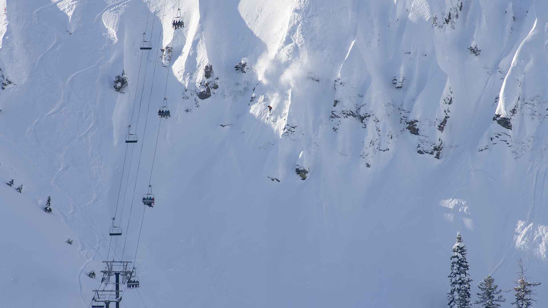 Skiers and snowboarders race down KT-22's famous "fingers" on a powder day.