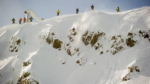 Skiers and snowboarders at the top of the Palisades on a storm day.