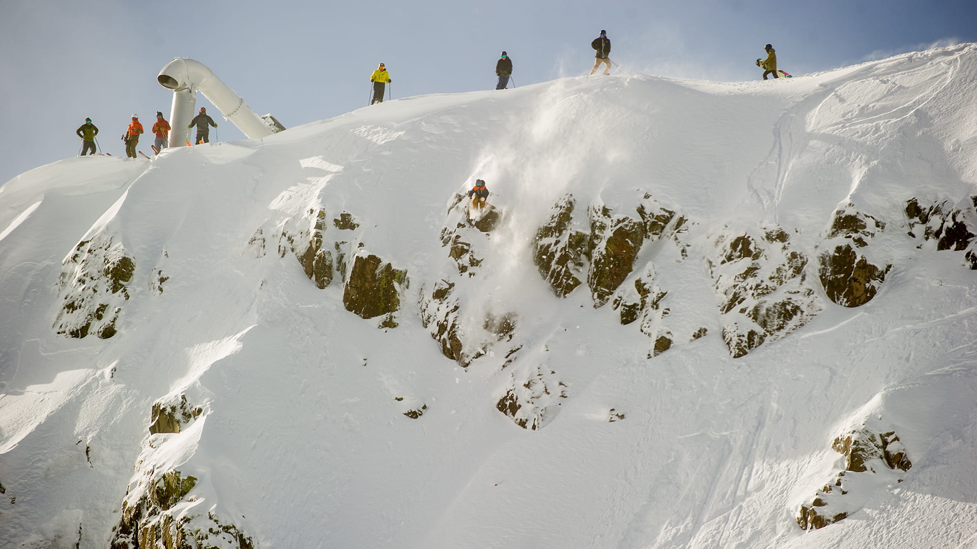Skiers and snowboarders at the top of the Palisades on a storm day.