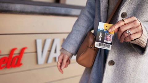 Image of woman holding Ikon Pass for valet perks at Westfield.