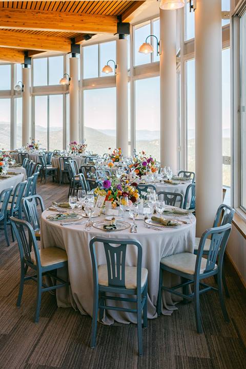 Chic table arrangement at a wedding venue in a rotunda-view restaurant. lake tahoe wedding venue featuring mountain views, full-service wedding catering, and a modern resort-style reception space at palisades tahoe