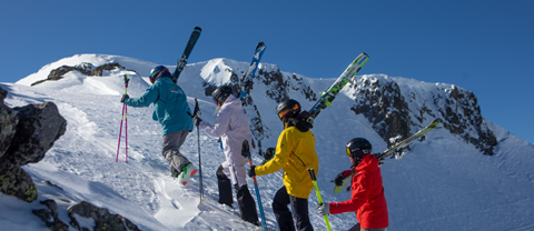 A group of skiers try to summit Palisades hike-to terrain on a bluebird day. 