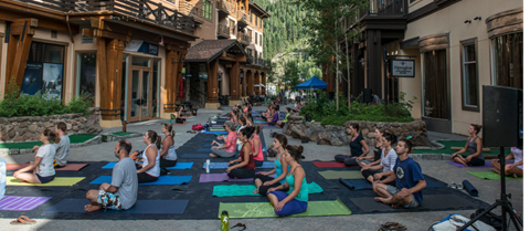 A group poses during a yoga class at Palisades Tahoe.
