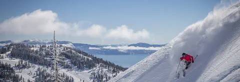 Skier on a powder day at Alpine Meadows with Lake Tahoe in the background