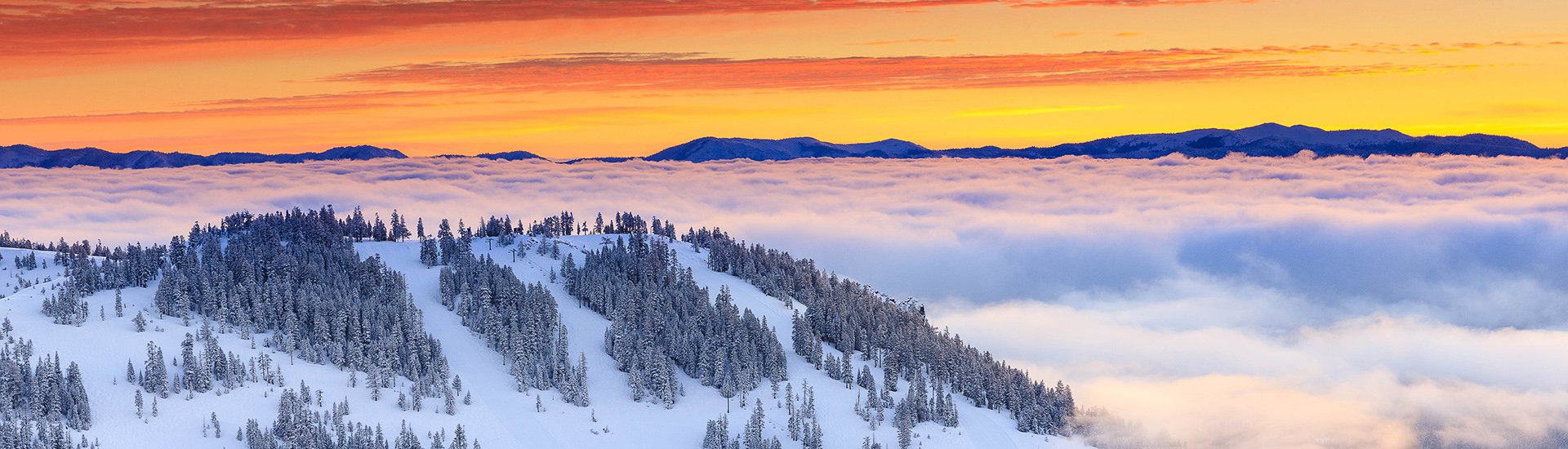 Colorful sunrise over Alpine Meadows with cloud inversion over Lake Tahoe