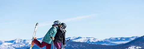 Couple kissing on skis at Palisades Tahoe, Lake Tahoe