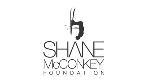 The logo for the Shane McConkey Foundation, featuring a skier doing a backflip. 