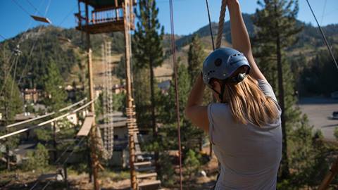 A girl enjoys the Treetop Adventure course in Olympic Valley.