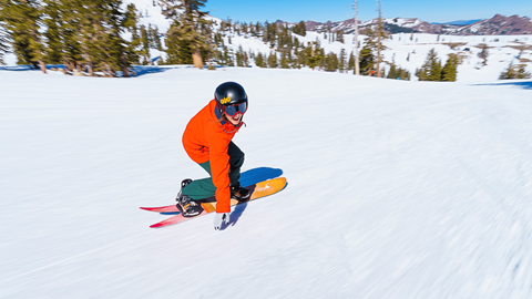 A snowboarder carves down a groomer at Palisades Tahoe.