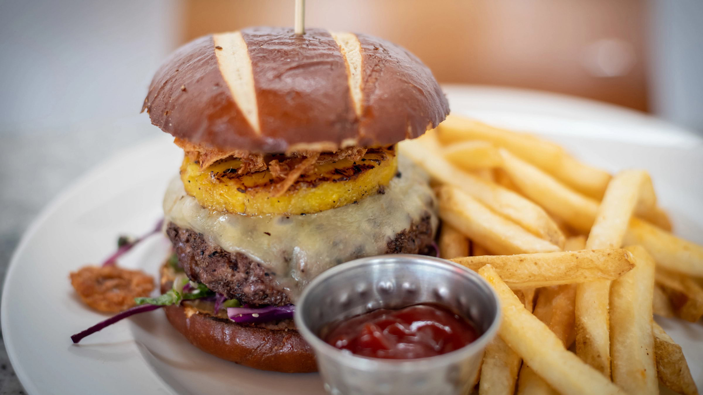 Cheeseburger with fries from Granite Bistro at Palisades Tahoe's High Camp