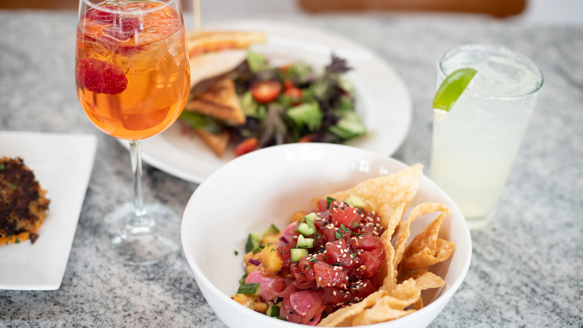 Poke dish and cocktail at Granite Bistro, located at Palisades Tahoe's High Camp