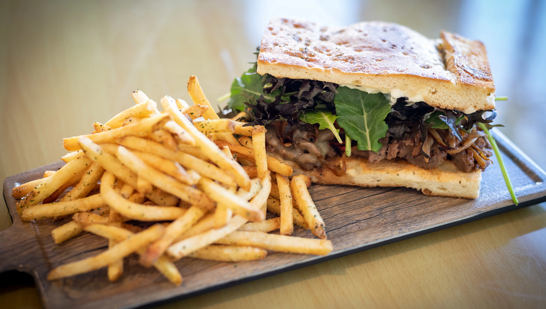 A feature of Last Chair Restaurant's menu is a steak sandwich with french fries. 