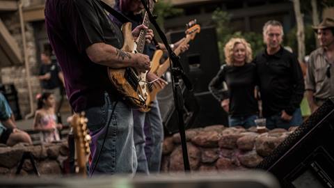 Blues musicians play an outdoor concert in the Village at Palisades Tahoe in Lake Tahoe California.