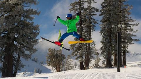 Kid getting air off a jump at Palisades Tahoe