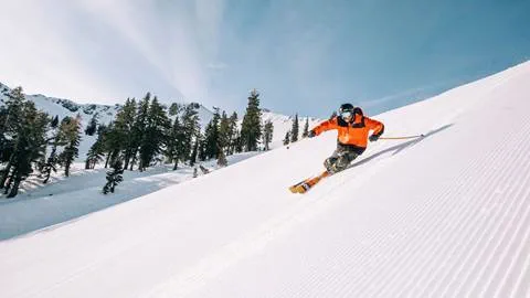 Skier on a groomer off Gold Coast Express at Palisades Tahoe