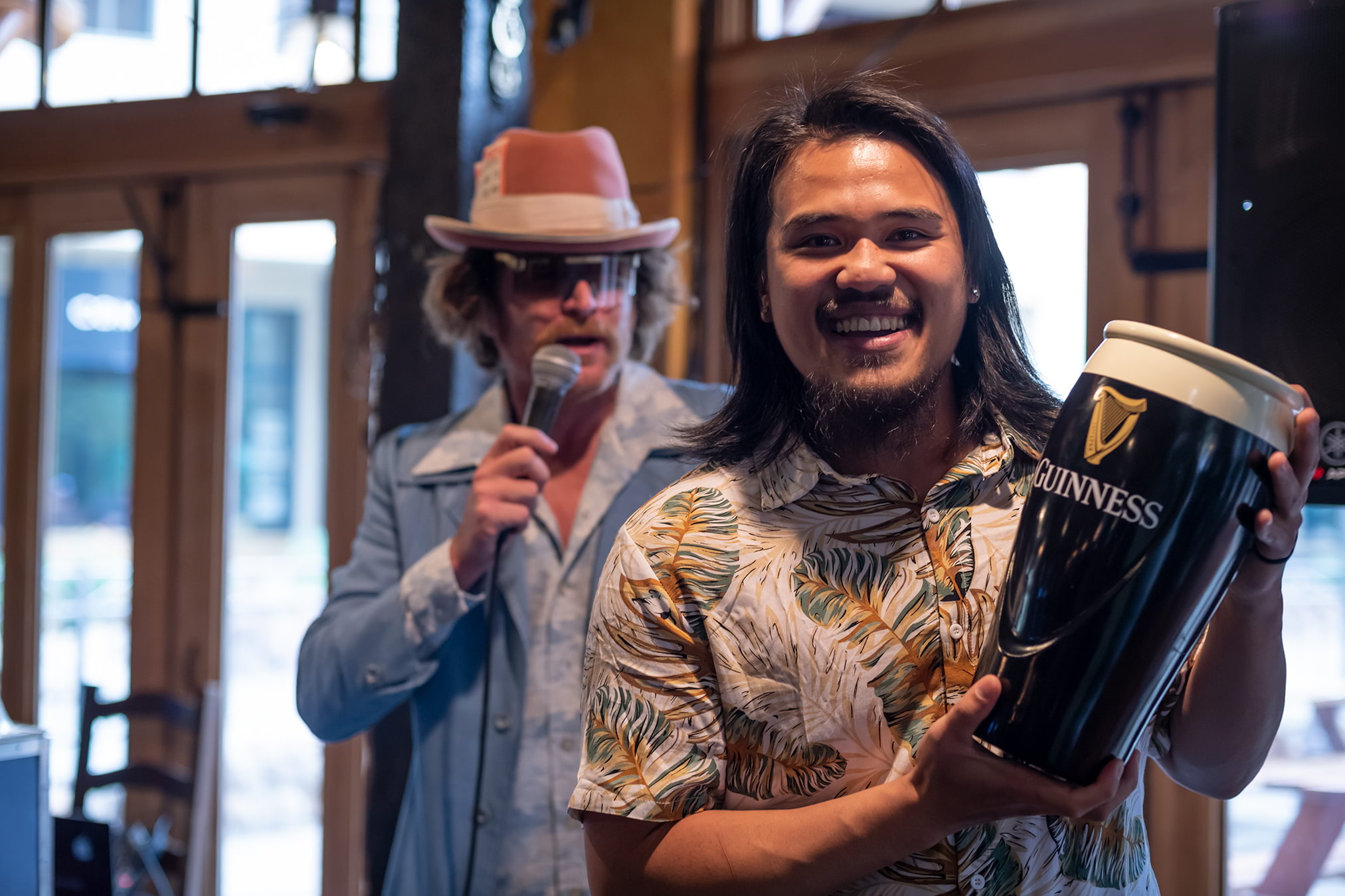A guest holds up a Guinness at a Bingo event in the Village at Palisades Tahoe. 