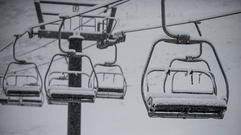 Snow falling over a chairlift at Palisades Tahoe on Dec 9, 2021