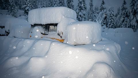 A machine  buried in snow at Palisades Tahoe during a huge Sierra storm
