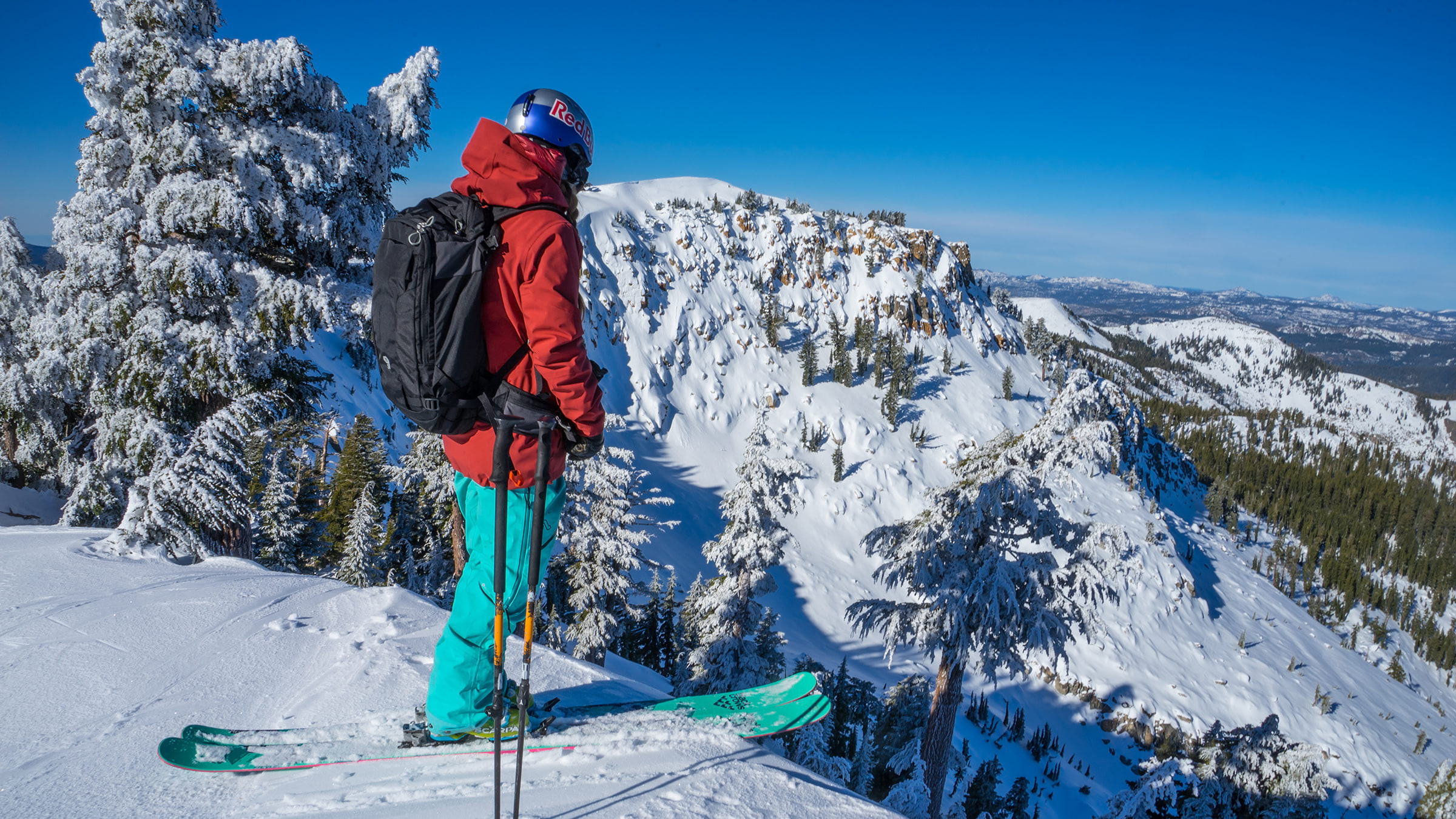Professional skier Michelle Parker looks out on backcountry terrain with Alpenglow Expedtions