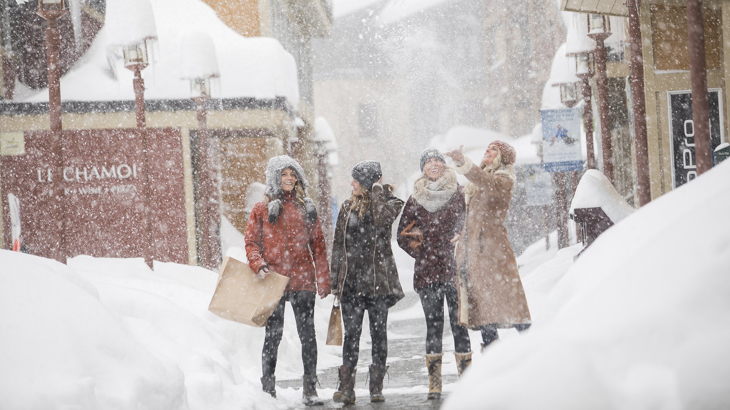 Women shopping on a snowy day in the Village at Palisades Tahoe