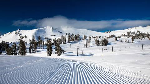 Pristine groomed run on the upper mountain at Olympic Valley in winter
