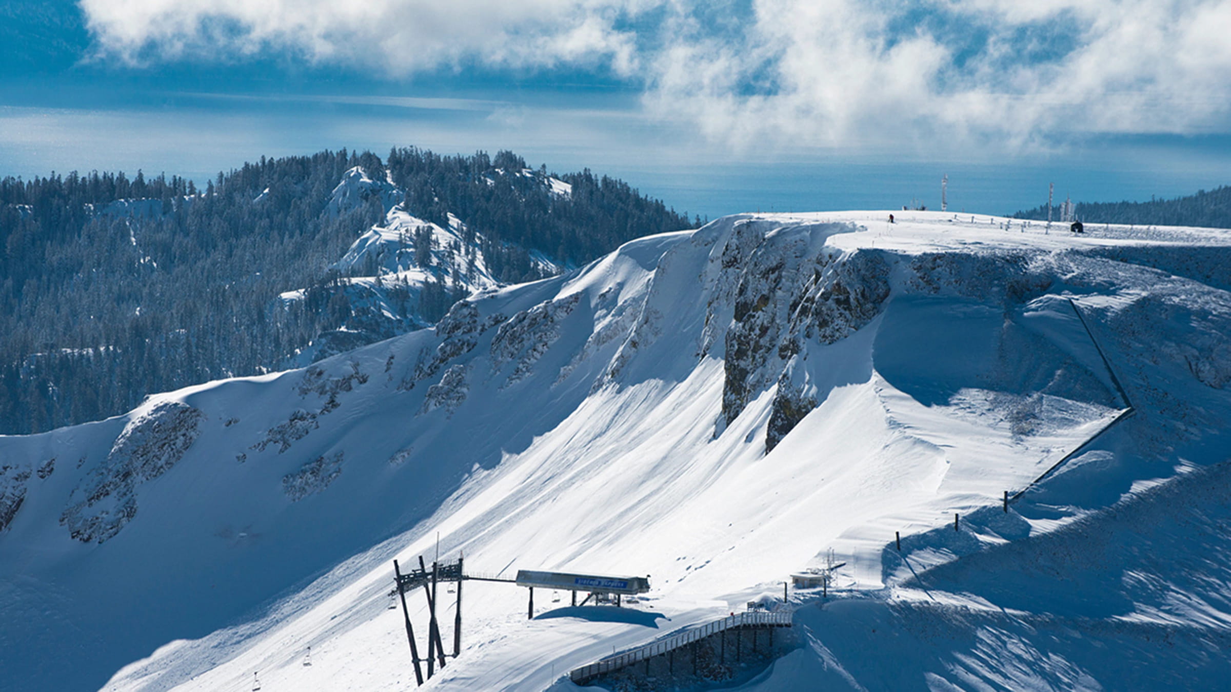 Iconic Palisades terrain that helped inspire the new resort name, with Lake Tahoe in the background