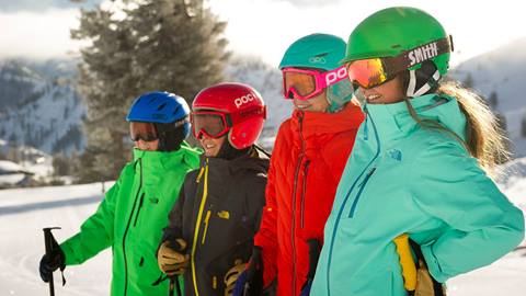 Team members of the Alpine Meadows Alpine Rangers Team stand at the top of a run.