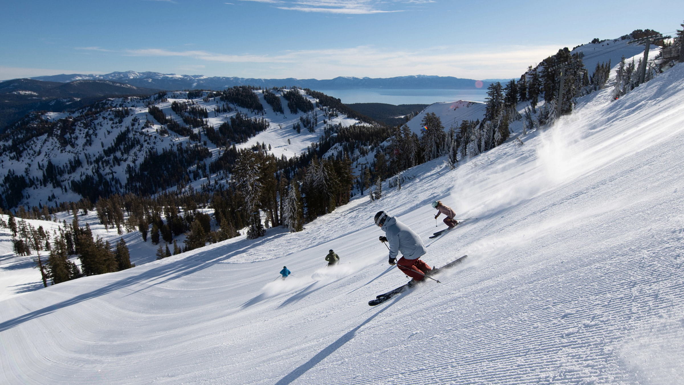 4 skiers in Wolverine Bowl at Palisades Tahoe 