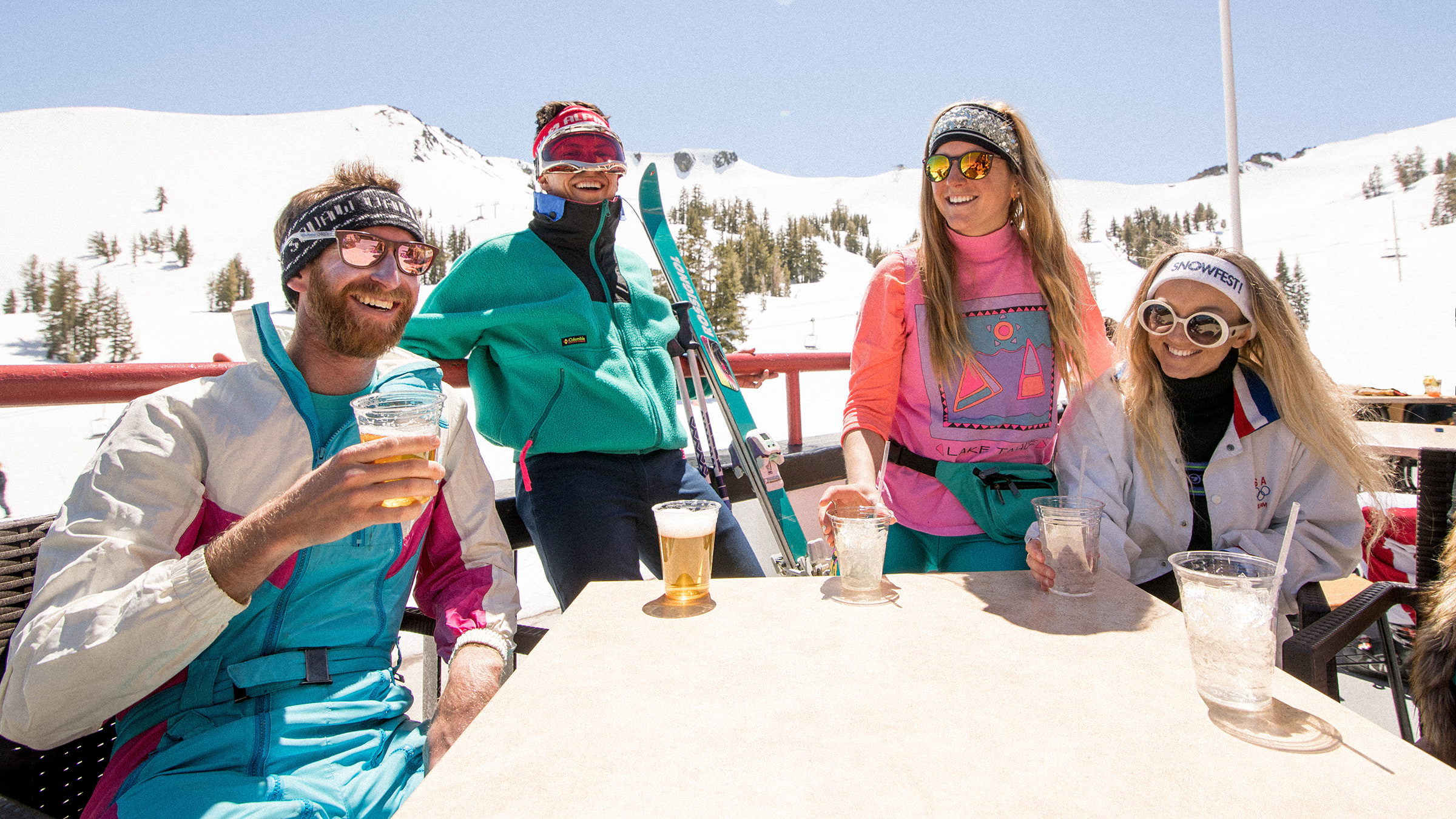 4 adults wearing retro ski gear at the top of Olympic Valley, Lake Tahoe
