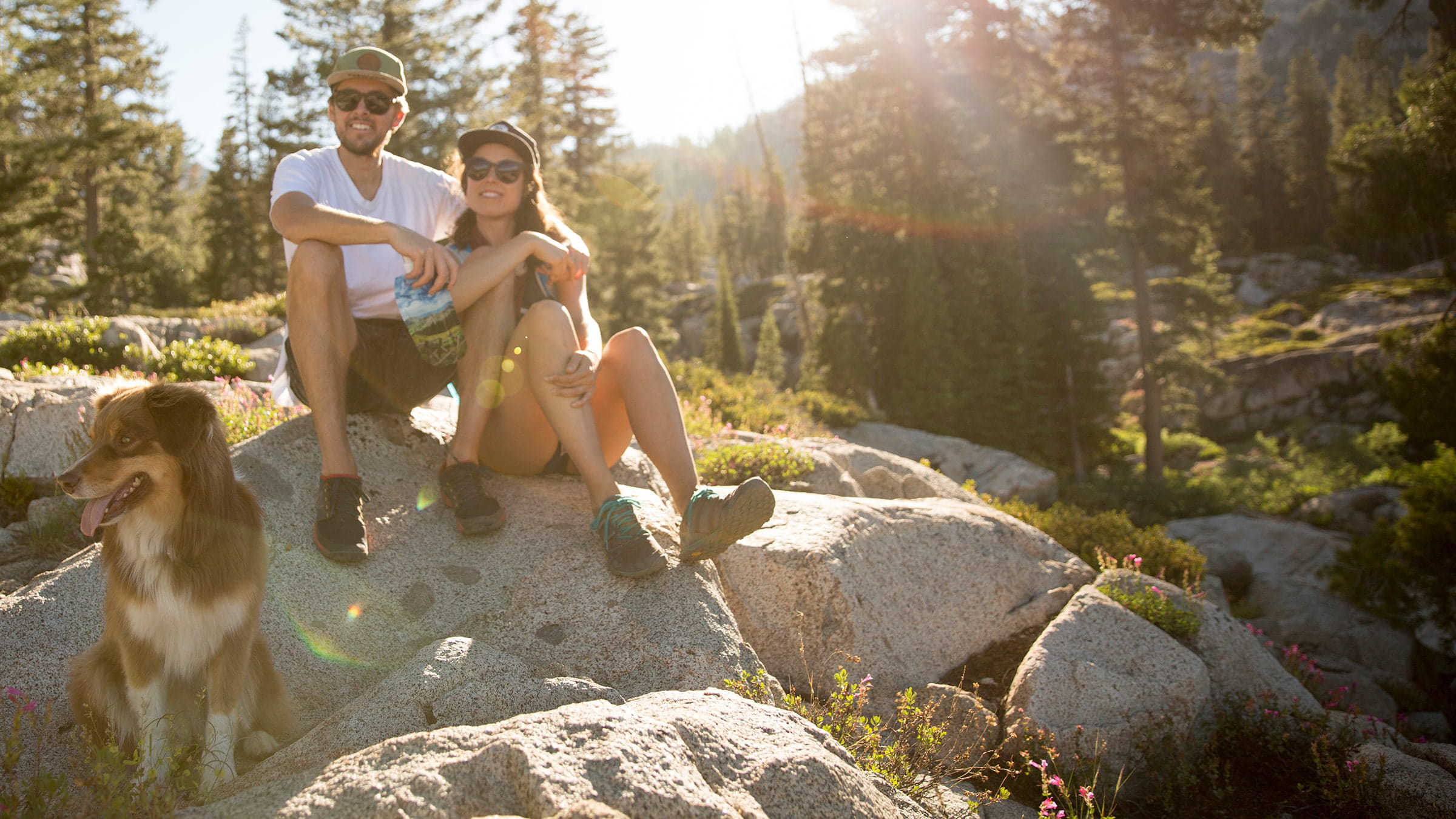 Couple resting on hike with their dog on Olympic Valley's Shirley Canyon trail