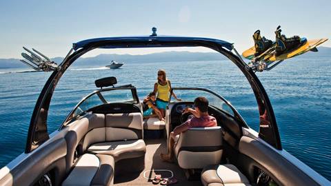 A family in a boat out on Lake Tahoe in the summer.