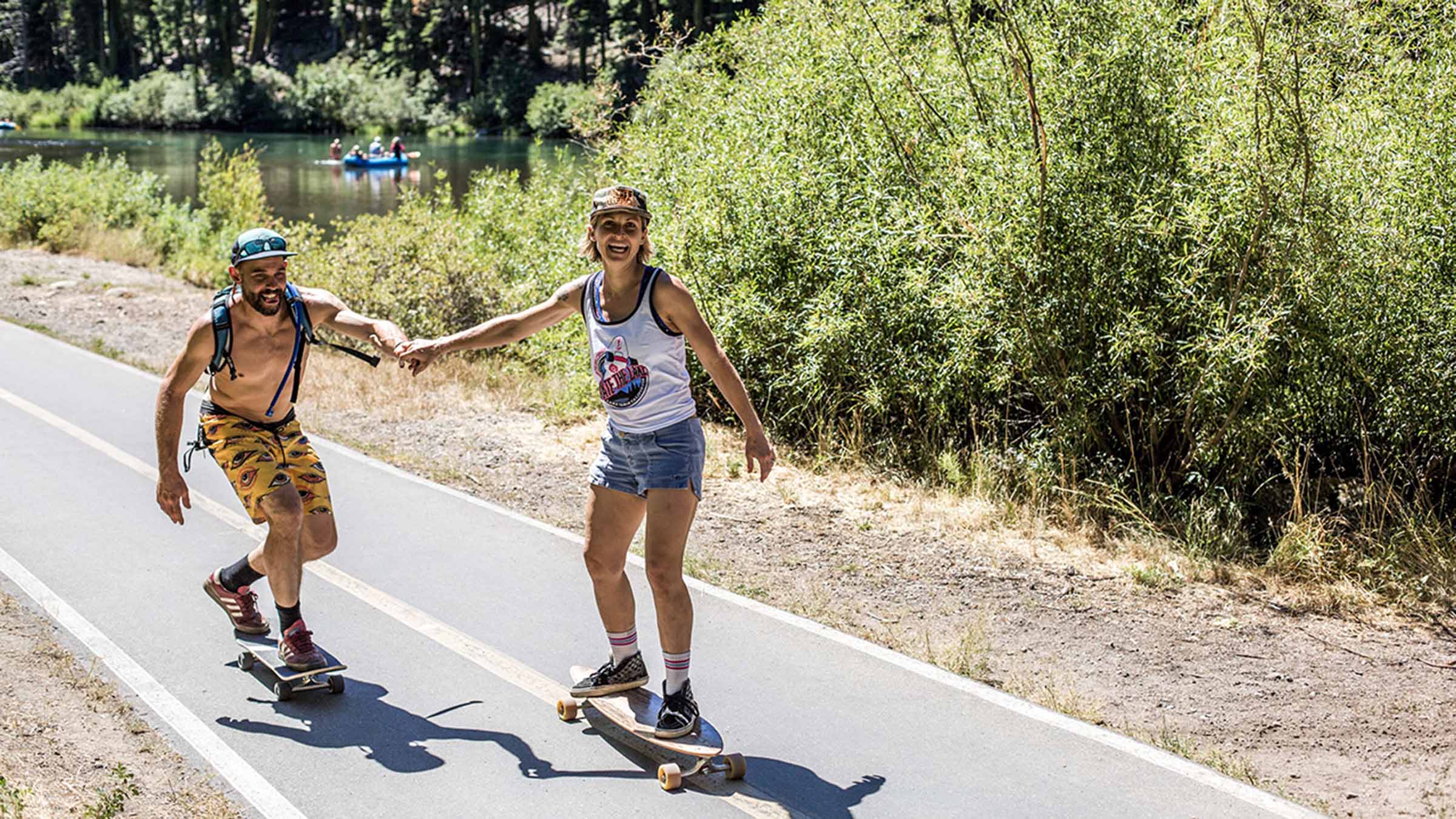 A couple skateboards down the Truckee River Bike Path in North Lake Tahoe.