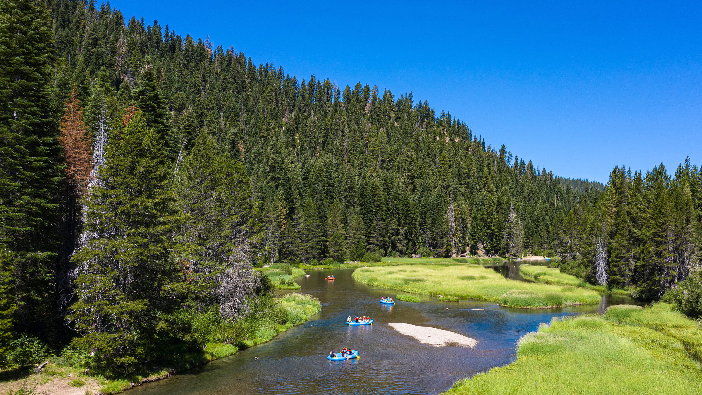 People floating down the Truckee River between Tahoe City and Alpine Meadows in summer