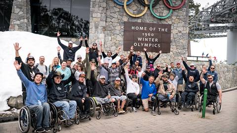 A group from Military to the Mountains sits under the Olympic Valley Funitel at Palisades Tahoe.