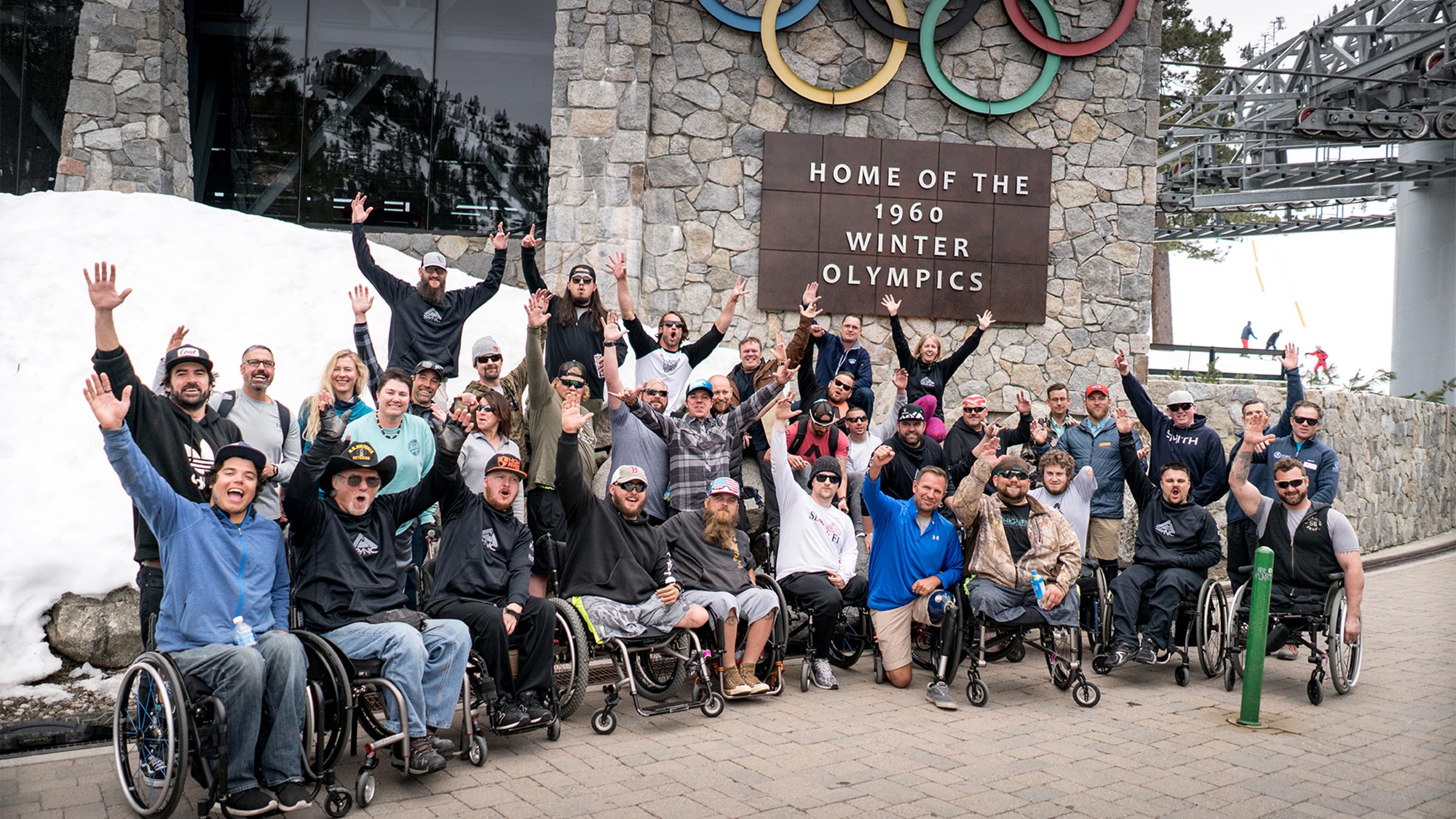 A group from Military to the Mountains sits under the Olympic Valley Funitel at Palisades Tahoe.
