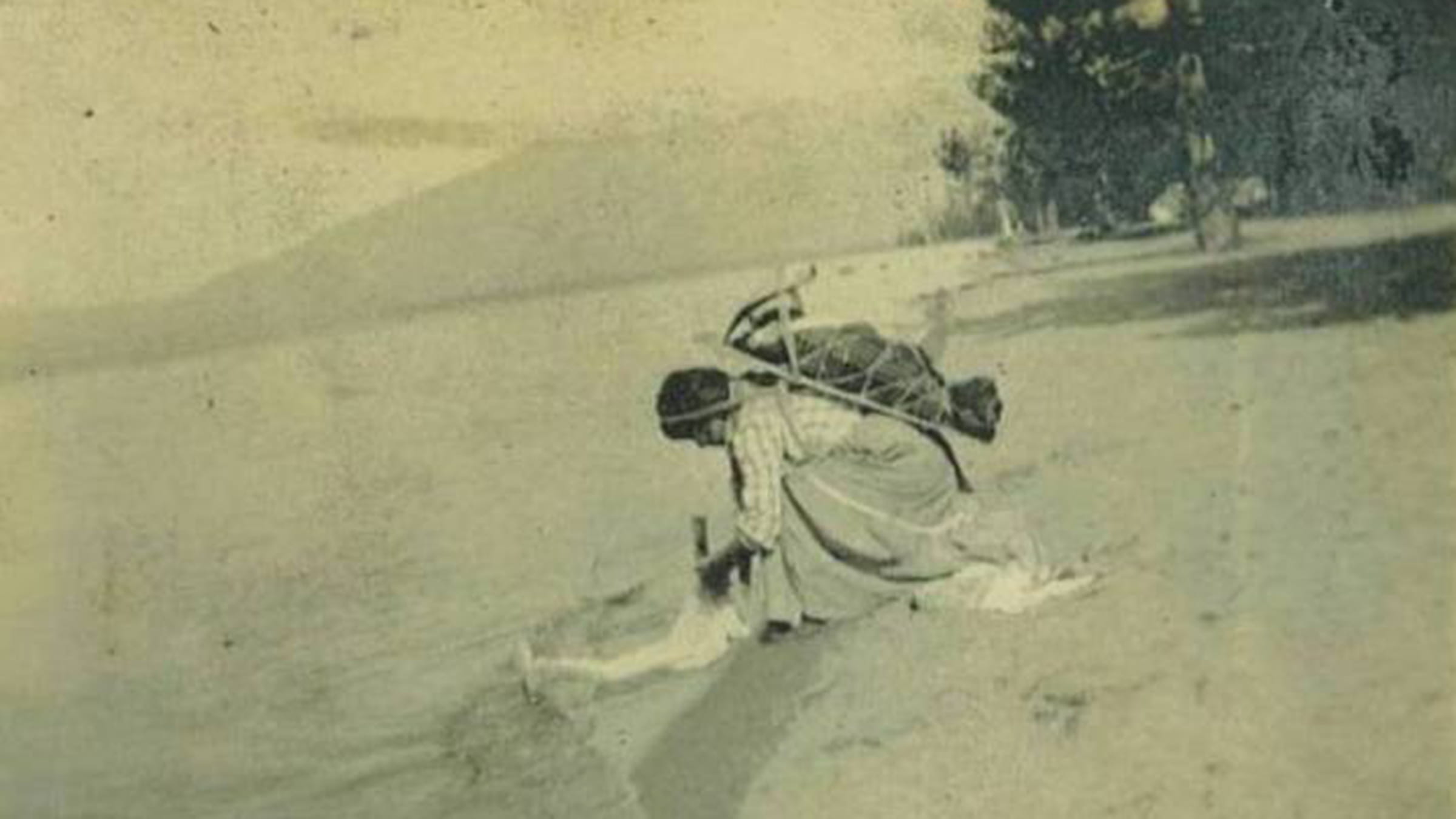 Historical photo of a Washoe woman and child at the shore of Lake Tahoe