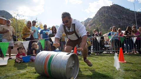 Keg Rolling for Oktoberfest with Tram face in background