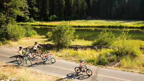 Family Biking on the bike path next to the Truckee River