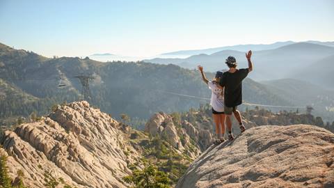 A couple waving to the aerial Tram on a hike in the summer at Squaw Valley
