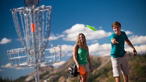 A couple playing disc golf at High Camp
