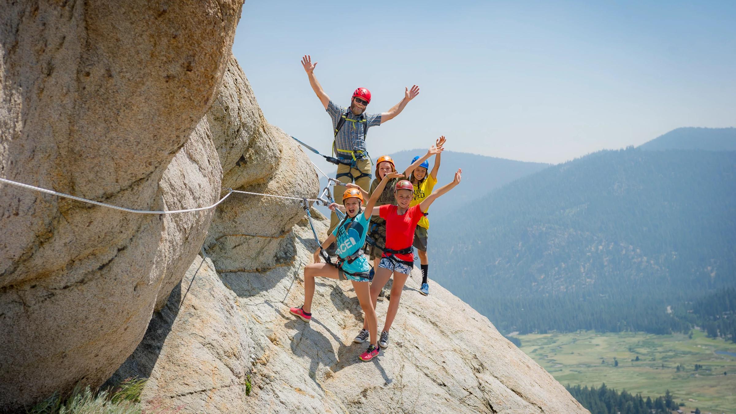Four kids are guided up Tram Face on the Via Ferrata