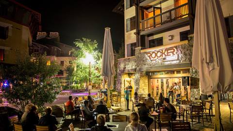 Crowd of people watching live music outside at night