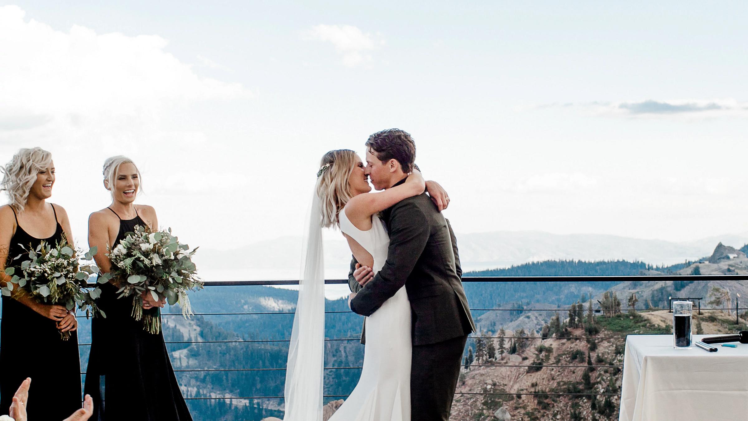 Bride and Groom kiss on High Camp deck at Squaw Valley