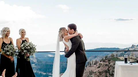 Bride and Groom kiss on High Camp deck at Squaw Valley