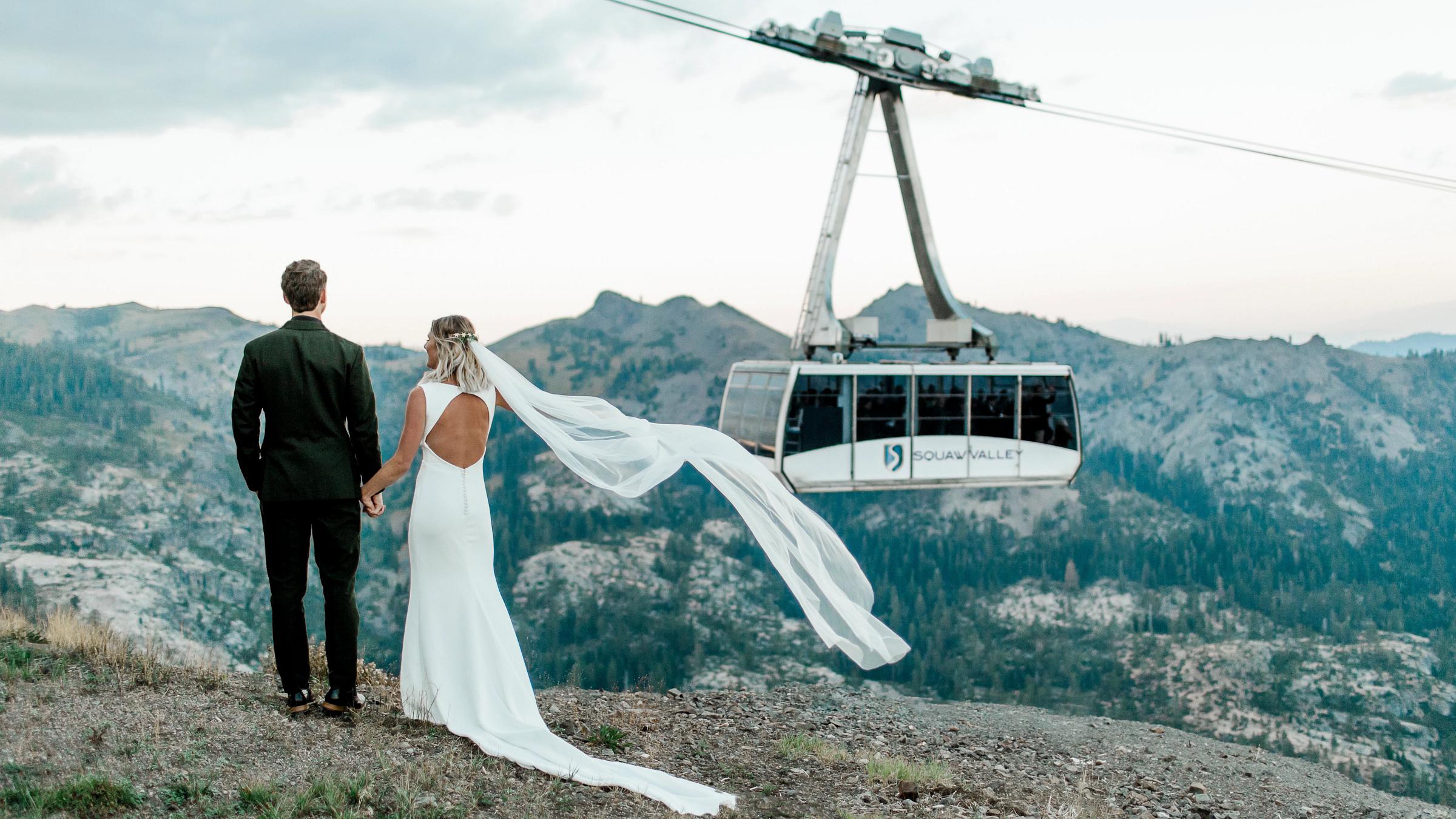 Bride and groom on looking out at the Ariel Tram at High Camp