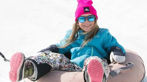 A little girls enjoying snow tubing at Snow Ventures