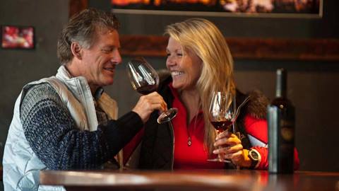 A couple enjoys wine & cheese for apres at Uncorked in The Village at Squaw Valley